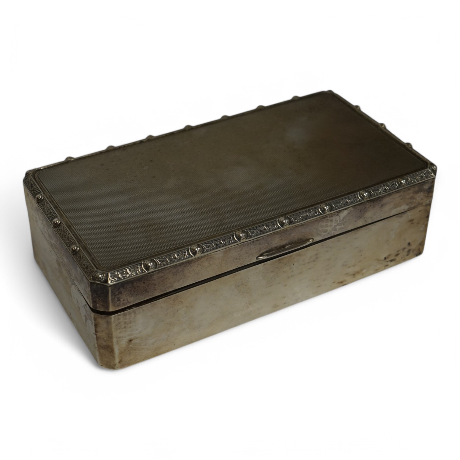 A George V silver mounted rectangular cigarette box, by Harrods Ltd, Birmingham, 1935, 16.6cm. Condition - poor to fair